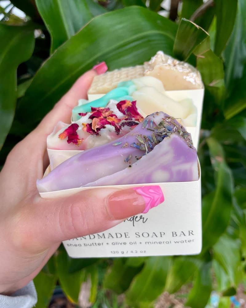 Soap bars with rose petals and lavender buds in their paper bands